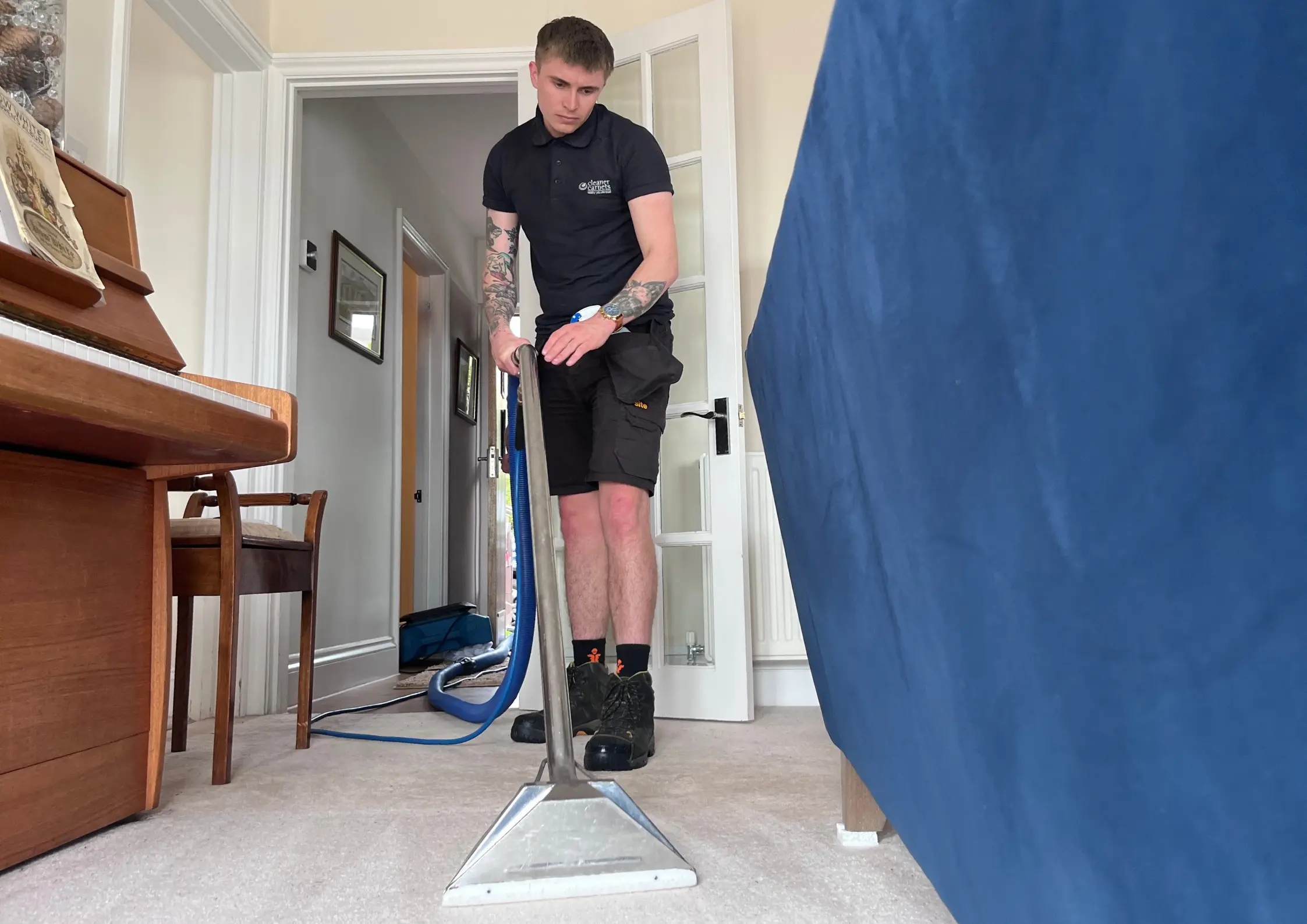 Experienced carpet cleaning technician using extraction equipment in an Exeter home.