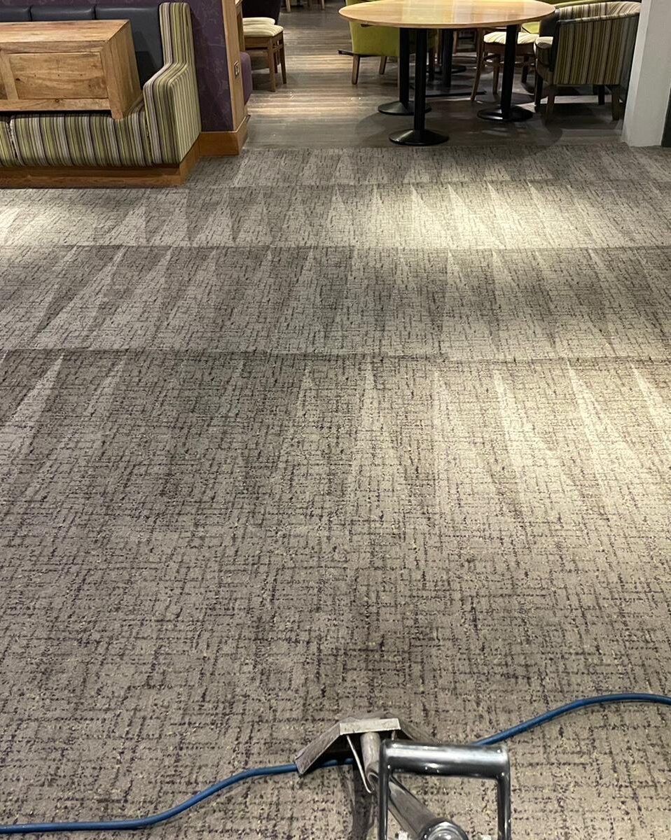 Cruise Ship Atrium Textile Maintenance Large-scale commercial carpet restoration underway in a luxury cruise ship lounge area.