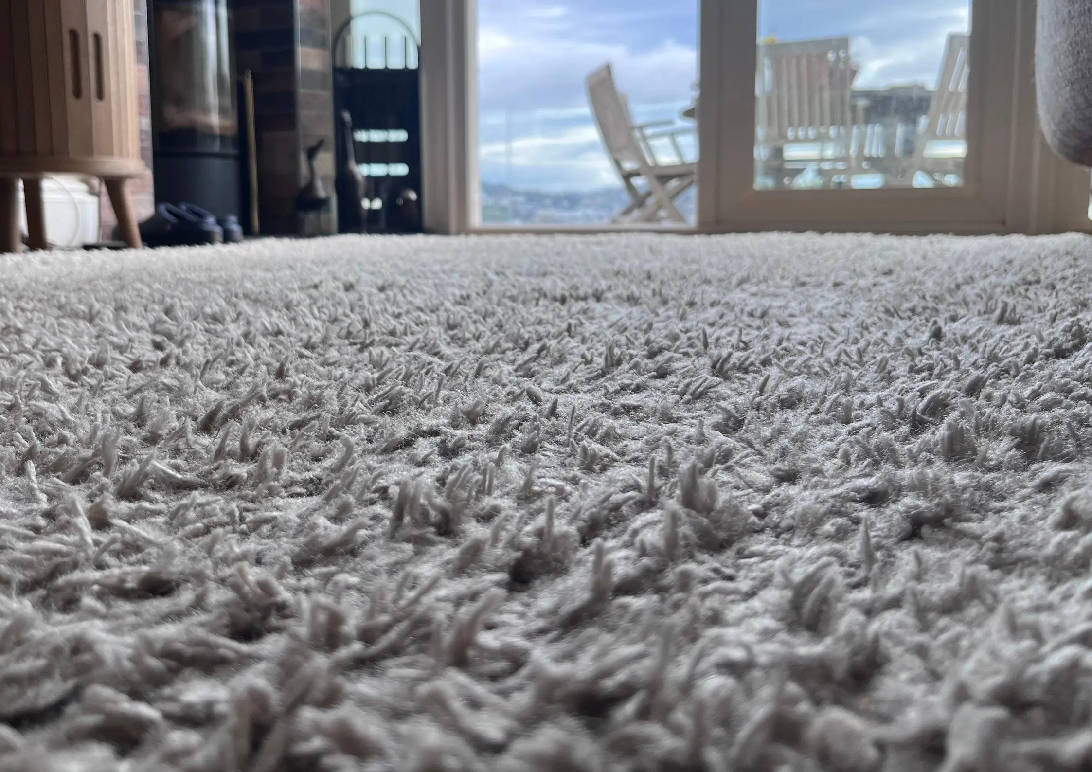 High-End Holiday Home Carpet Care A minimalist luxury living room overlooking the South Devon coast with immaculate wall-to-wall carpets.