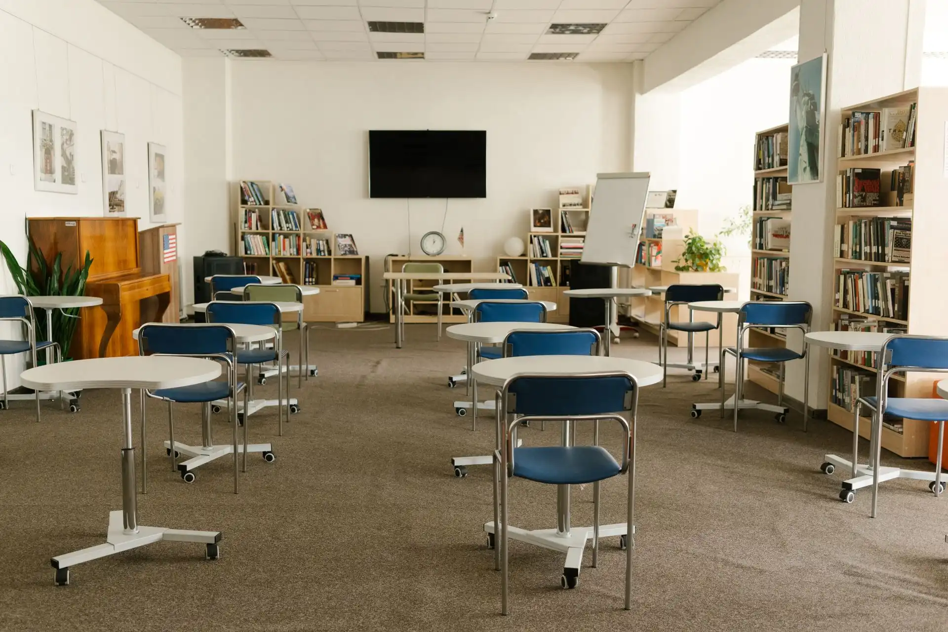 An empty primary school classroom featuring perfectly clean, sanitized carpets after holiday maintenance.