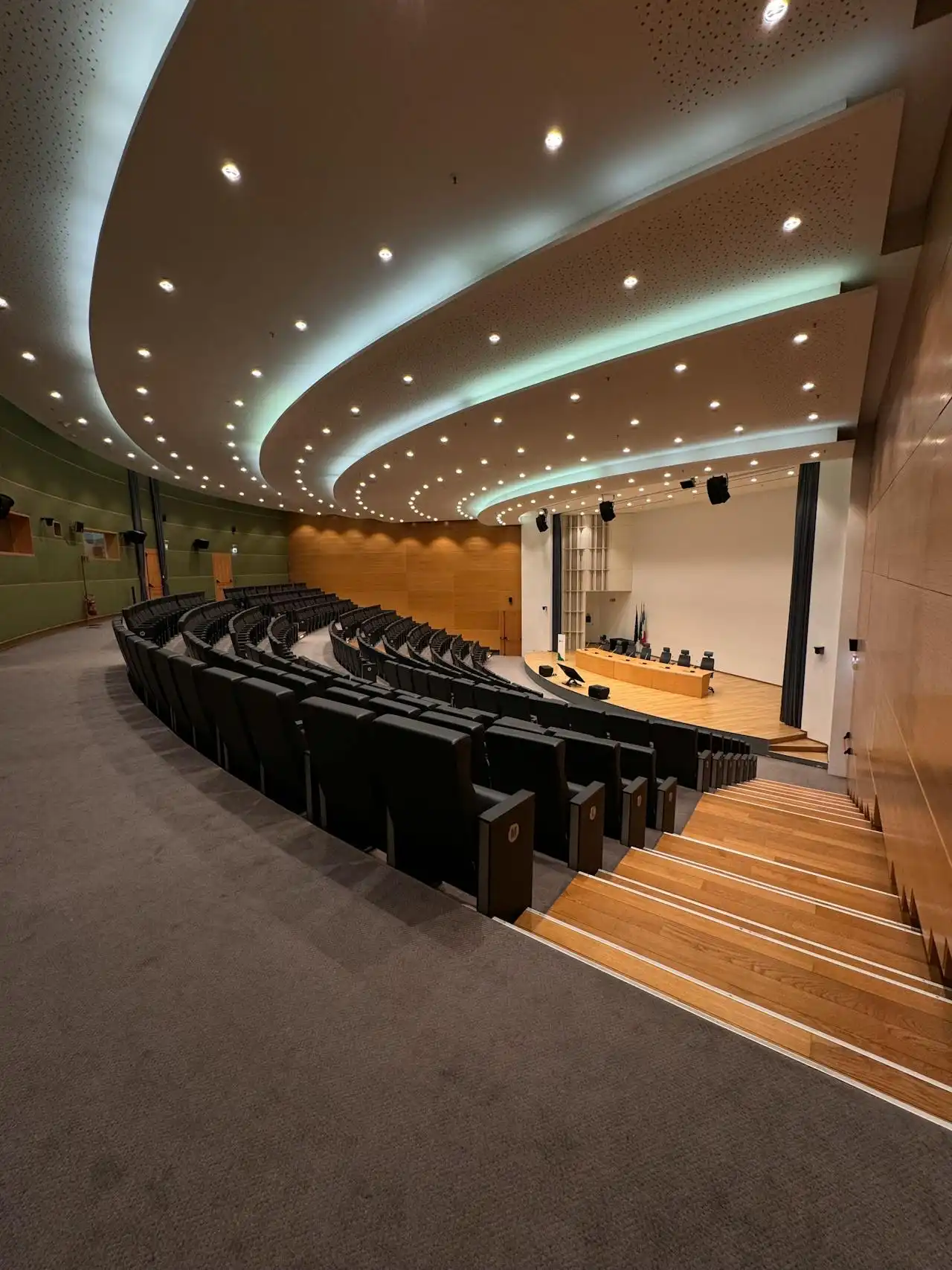 Professional commercial carpet extraction underway between rows of seating in a large Exeter lecture hall.
